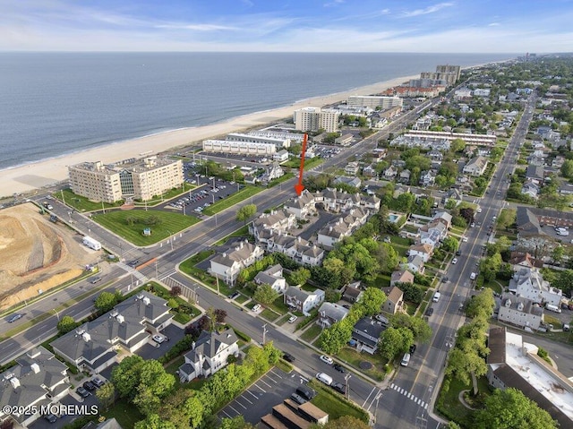 view of property location with a nearby body of water and nearby urban area