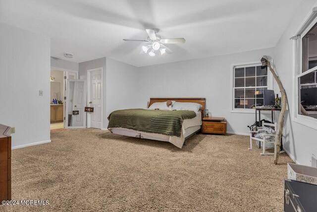 carpeted bedroom with baseboards and a ceiling fan