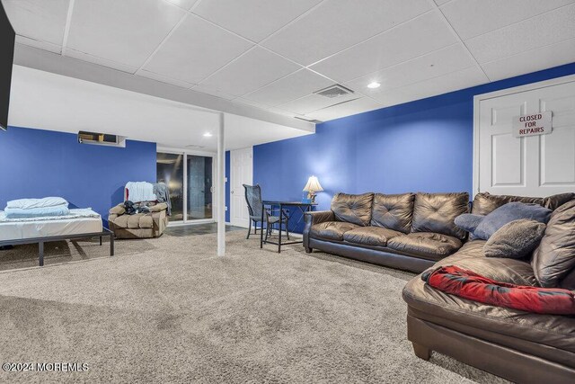 carpeted living area with a paneled ceiling, recessed lighting, and baseboards