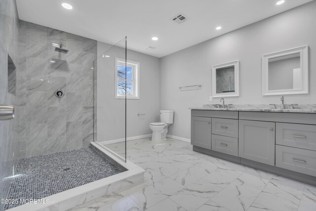 full bathroom featuring recessed lighting, toilet, baseboards, a marble finish shower, and double vanity