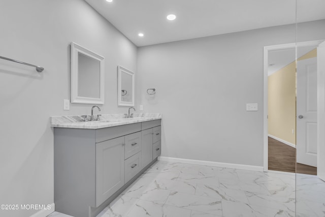 bathroom featuring recessed lighting, double vanity, baseboards, and marble look tiles