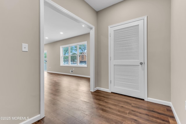 entrance foyer with dark wood-style floors, baseboards, and recessed lighting