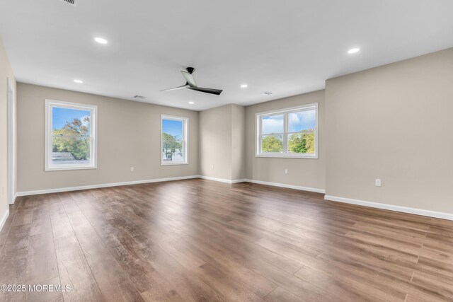 spare room with ceiling fan, wood finished floors, baseboards, and recessed lighting