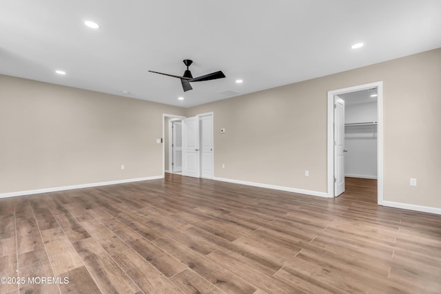 unfurnished bedroom with wood finished floors, baseboards, recessed lighting, and ceiling fan