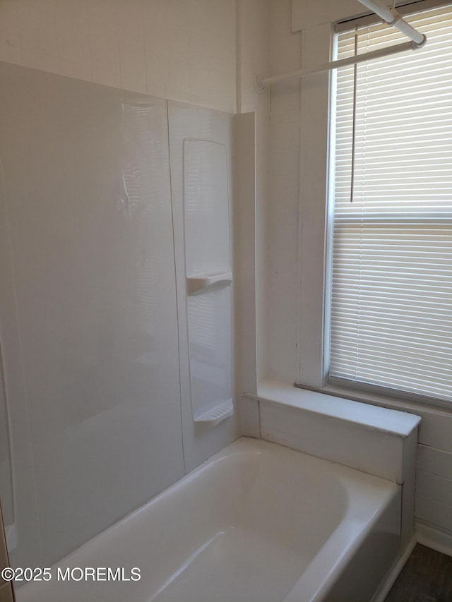 bathroom featuring a tub to relax in