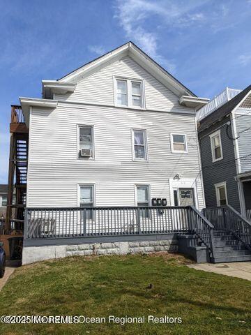 back of house with a yard