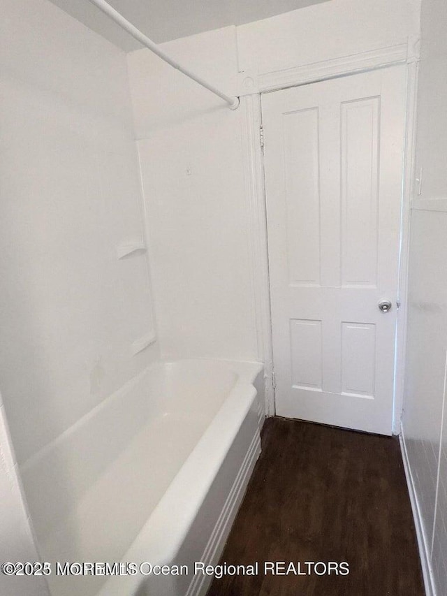 bathroom with wood finished floors and shower / bath combination