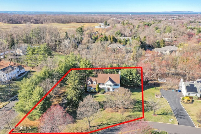 aerial view of property and surrounding area featuring property parcel outlined