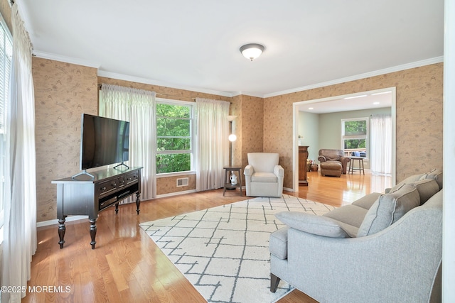 24 Statesboro Rd, Freehold, NJ 07728 - living area featuring wallpapered walls, plenty of natural light, wood finished floors, crown molding, and baseboards