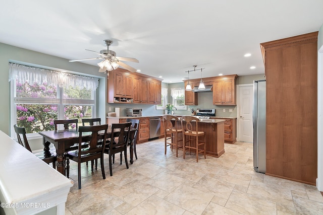 24 Statesboro Rd, Freehold, NJ 07728 - kitchen with appliances with stainless steel finishes, recessed lighting, a center island, brown cabinets, and light countertops