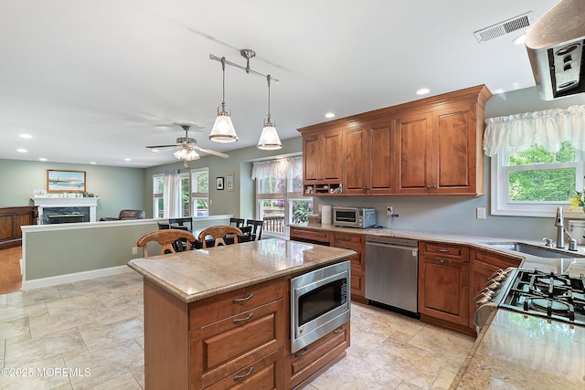 24 Statesboro Rd, Freehold, NJ 07728 - kitchen featuring stainless steel appliances, a sink, recessed lighting, a fireplace, and pendant lighting