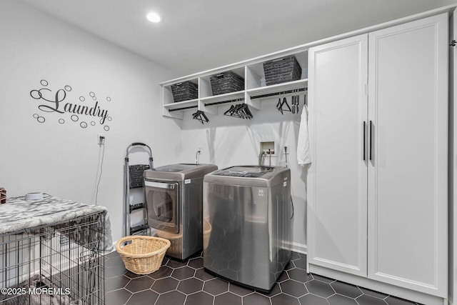 laundry area featuring washer and clothes dryer, dark tile patterned flooring, cabinet space, recessed lighting, and wet bar