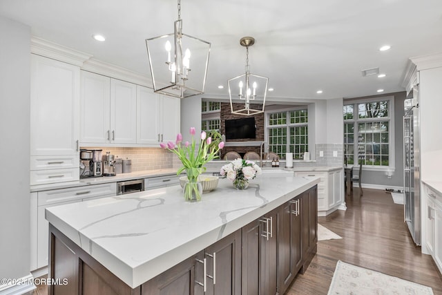 kitchen with tasteful backsplash, white cabinets, and recessed lighting