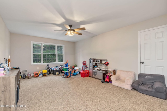 recreation room featuring carpet floors and a ceiling fan