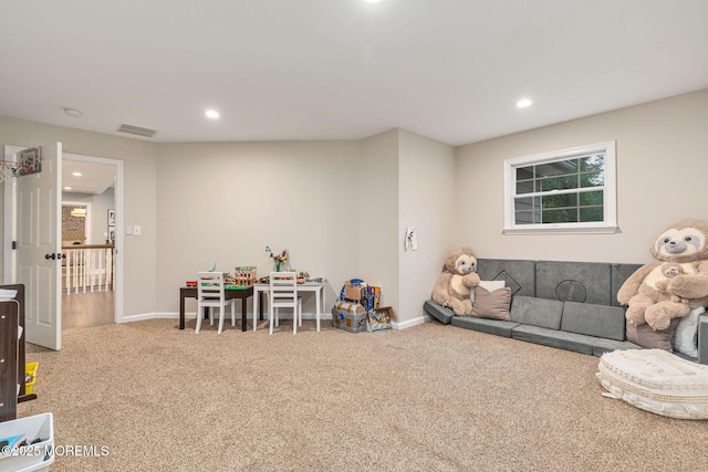 carpeted living area featuring recessed lighting and baseboards