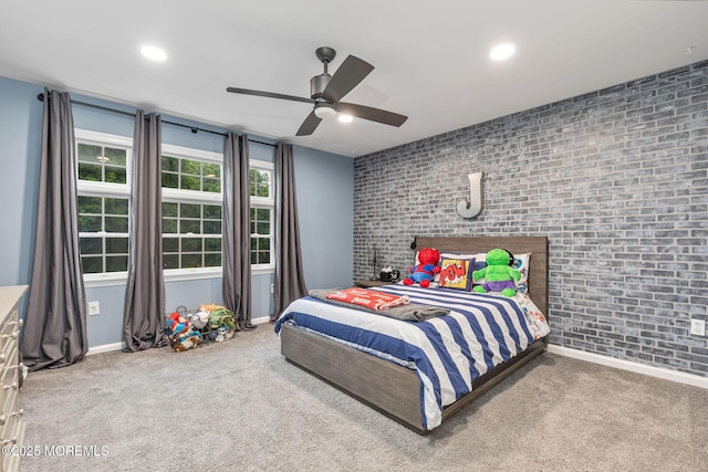 carpeted bedroom with brick wall, baseboards, recessed lighting, and ceiling fan