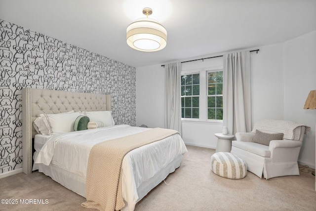 bedroom featuring wallpapered walls, carpet flooring, an accent wall, and baseboards