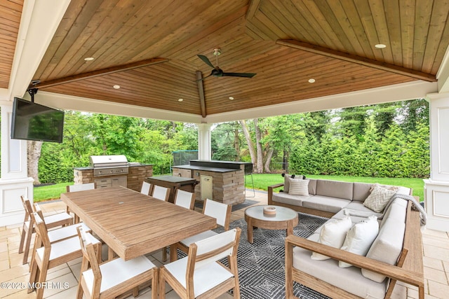 view of patio featuring area for grilling, outdoor dining space, an outdoor hangout area, and a ceiling fan