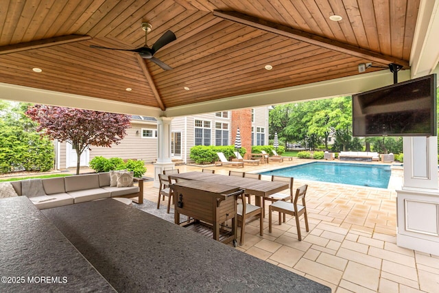 view of patio / terrace with an outdoor hangout area, a gazebo, an outdoor pool, outdoor dining space, and a ceiling fan