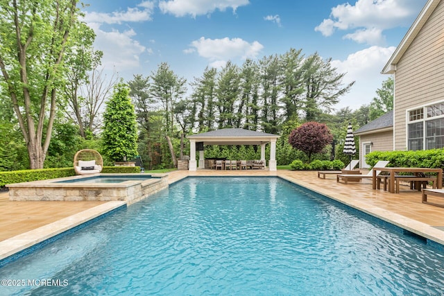 view of swimming pool featuring a gazebo, a patio, and a pool with connected hot tub