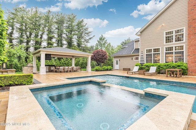 view of pool with a gazebo, a patio, and a pool with connected hot tub