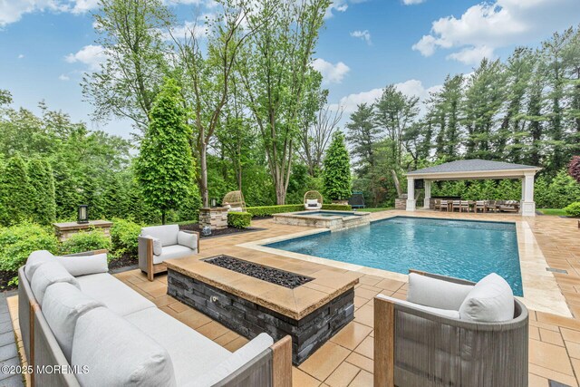 3 Ardmore Pl, Holmdel, NJ 07733 - view of swimming pool with a gazebo, a patio area, an outdoor living space with a fire pit, view of wooded area, and a pool with connected hot tub