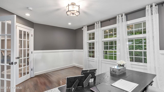 office area with wood finished floors, wainscoting, french doors, and a chandelier
