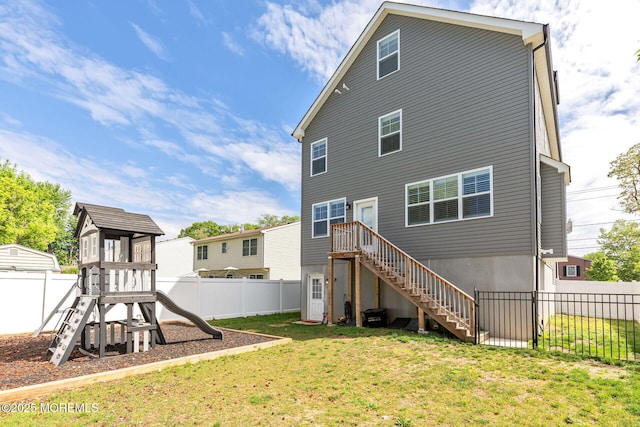 rear view of house with a playground and stairs