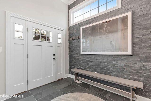 entrance foyer with dark marble finish flooring and baseboards
