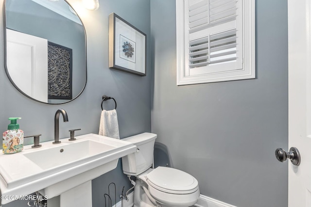 bathroom with toilet and a sink