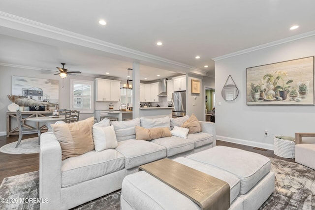 living area with baseboards, crown molding, recessed lighting, dark wood-type flooring, and ceiling fan