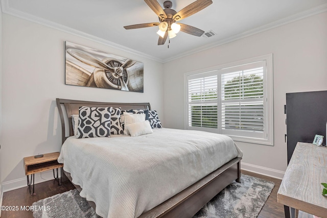 bedroom with ornamental molding, baseboards, wood finished floors, and ceiling fan
