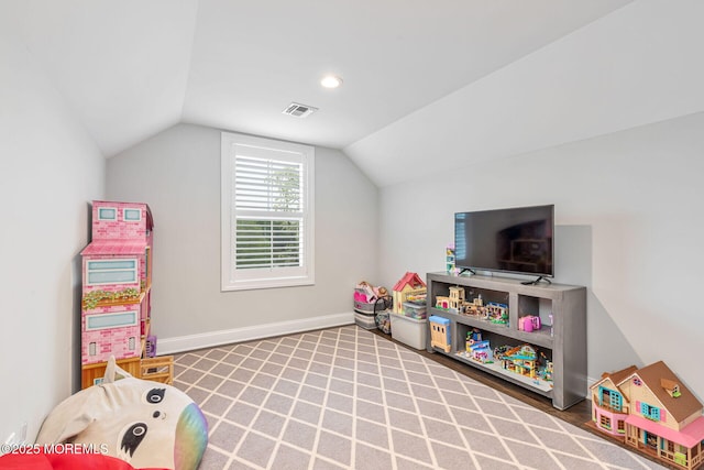 game room with lofted ceiling and baseboards