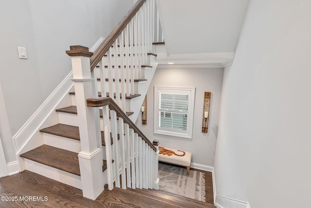 staircase with baseboards, wood finished floors, and crown molding