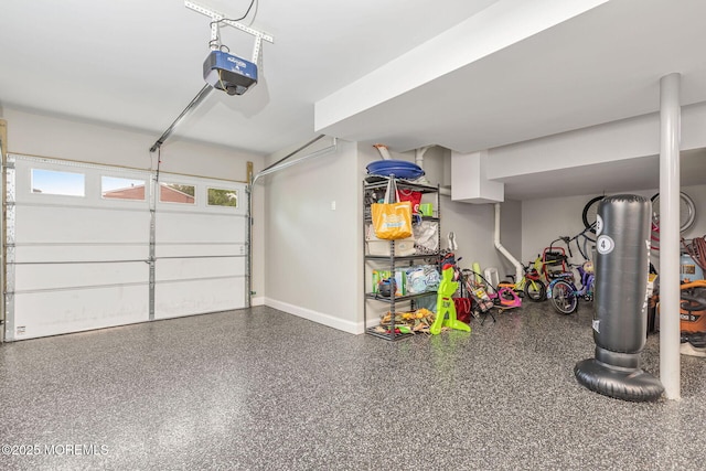 garage with a garage door opener and baseboards