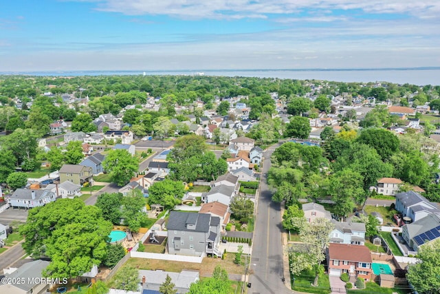 aerial overview of property's location with nearby suburban area and a large body of water