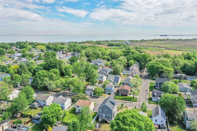 aerial overview of property's location with nearby suburban area and a nearby body of water