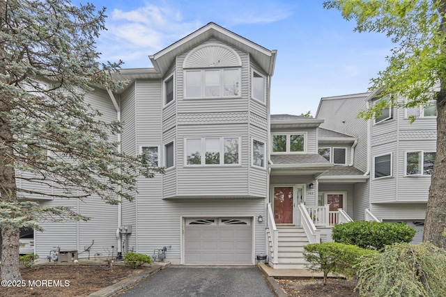 142 Orchid Ct, Toms River, NJ 08753 - view of front of house with a garage, driveway, and roof with shingles