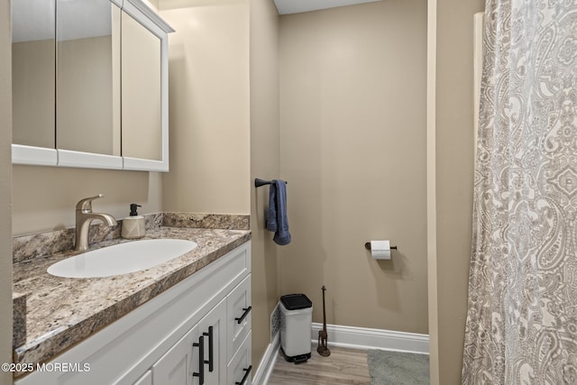 142 Orchid Ct, Toms River, NJ 08753 - full bathroom with vanity, wood finished floors, baseboards, and toilet