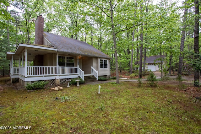 3257 Ridgeway Blvd, Manchester, NJ 08759 - view of front of home with covered porch, a chimney, and a garage