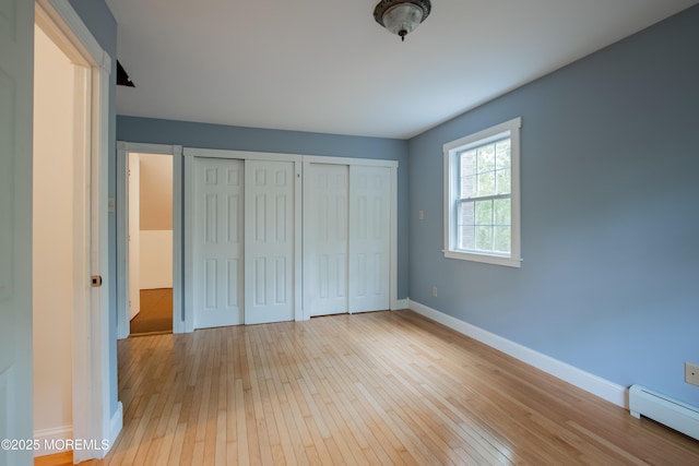 3257 Ridgeway Blvd, Manchester, NJ 08759 - unfurnished bedroom featuring baseboard heating, two closets, light wood-style flooring, and baseboards