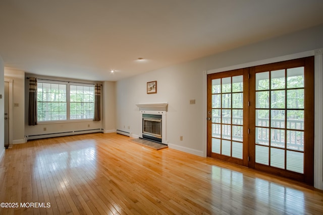3257 Ridgeway Blvd, Manchester, NJ 08759 - unfurnished living room with a baseboard radiator, light wood-type flooring, a glass covered fireplace, baseboards, and recessed lighting