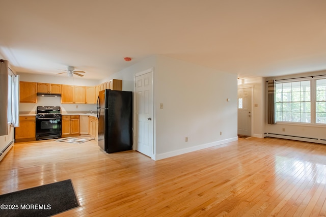 3257 Ridgeway Blvd, Manchester, NJ 08759 - kitchen featuring black appliances, a baseboard heating unit, under cabinet range hood, a ceiling fan, and light wood-type flooring