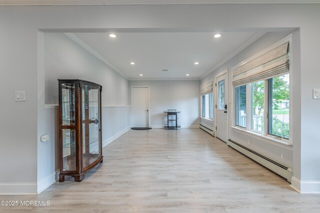129 Guadeloupe Dr, Toms River, NJ 08757 - unfurnished living room with a baseboard heating unit, light wood-style floors, crown molding, recessed lighting, and baseboards
