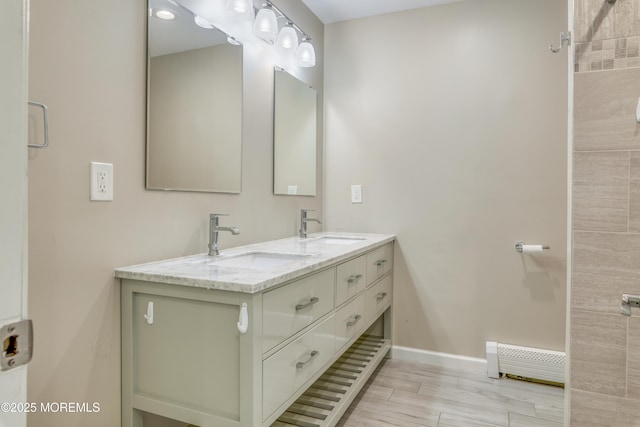 129 Guadeloupe Dr, Toms River, NJ 08757 - bathroom featuring baseboard heating, baseboards, and double vanity