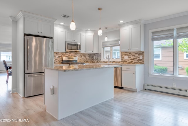 129 Guadeloupe Dr, Toms River, NJ 08757 - kitchen with stainless steel appliances, a baseboard heating unit, light wood finished floors, healthy amount of natural light, and crown molding