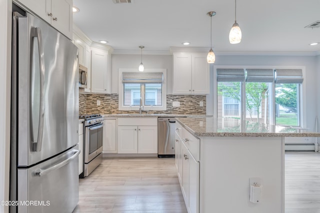 129 Guadeloupe Dr, Toms River, NJ 08757 - kitchen featuring stainless steel appliances, crown molding, light wood-style floors, a kitchen island, and white cabinets