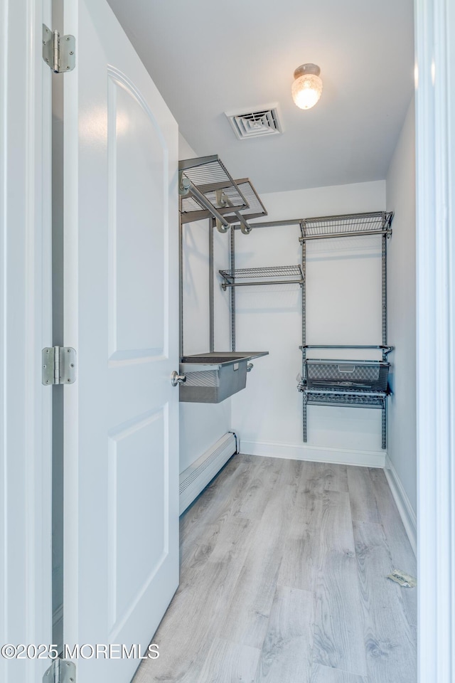 129 Guadeloupe Dr, Toms River, NJ 08757 - spacious closet featuring wood finished floors and a baseboard radiator