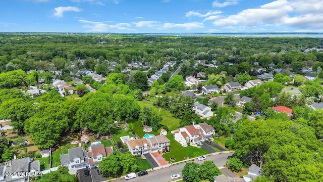 aerial view of residential area featuring a heavily wooded area