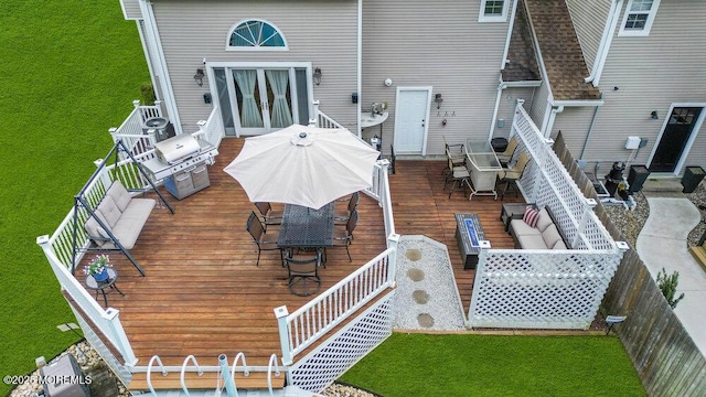 back of house with outdoor dining area, french doors, and a deck